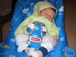 Sometimes you need to bundle up to get in the bouncy chair. Taken on August 25th, 2007